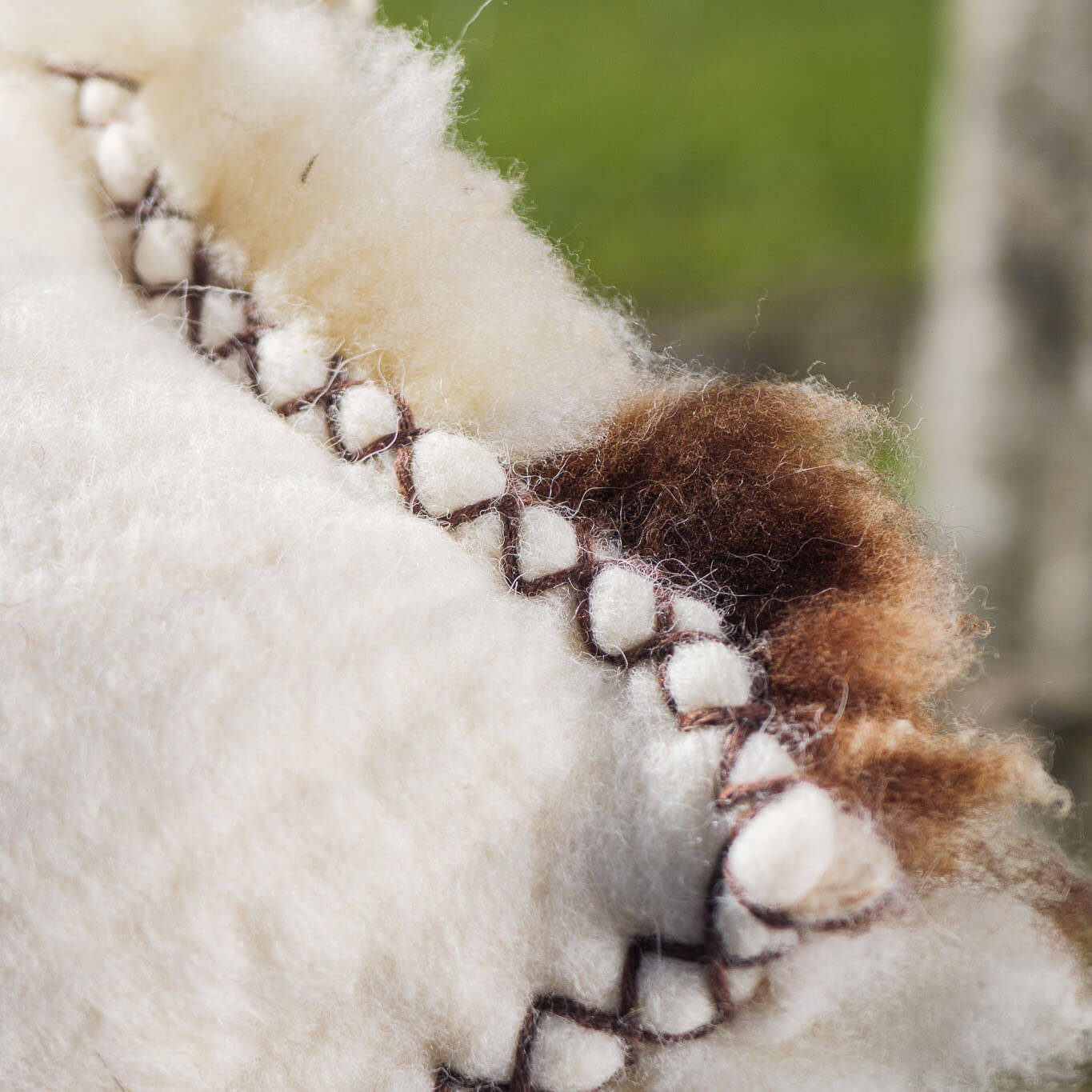Brown-and-white felted wool cushion
